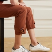women sitting with capris and sneakers on