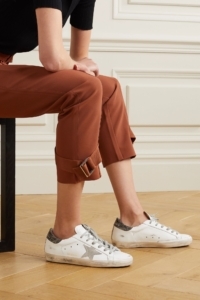 women sitting with capris and sneakers on