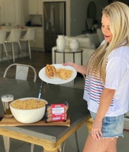blonde girl with budweiser brats and macaroni salad