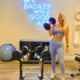 blonde woman in home gym holding dumbbell