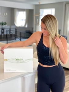 girl with Prolon diet box on kitchen island