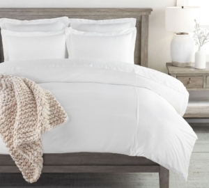 Pottery Barn all white bedding, product photo on king size bed in a bedroom