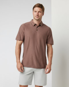 Man wearing tan golf polo and khaki shorts