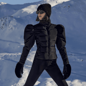 brunette woman on mountain wearing cute all black apres ski outfit