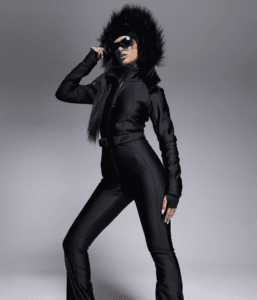 Brunette woman wearing black ski suit and faux fur headband in black