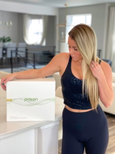 blonde woman standing next to Prolon 5-day Diet box